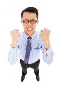 angry businessman make a fist  to yell
