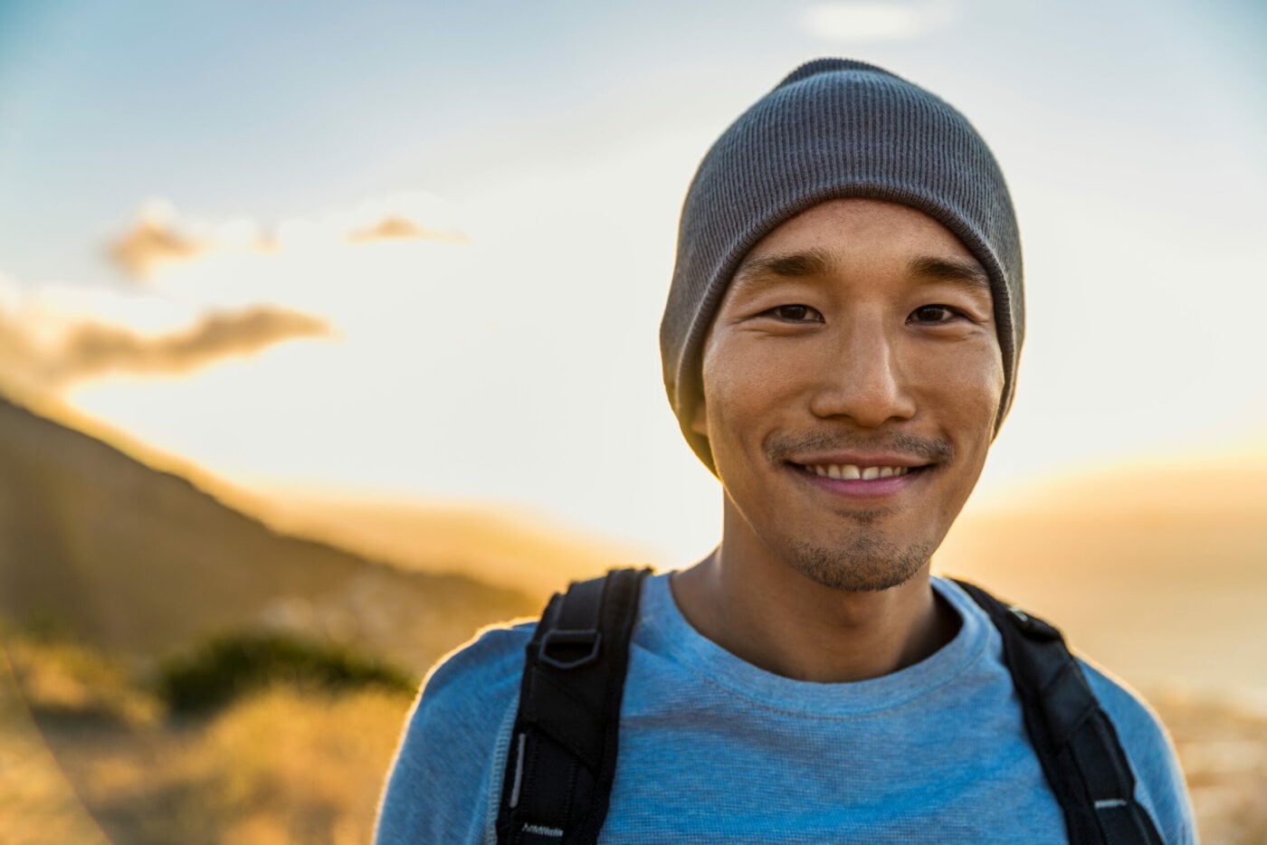 young man in a beanie smiling