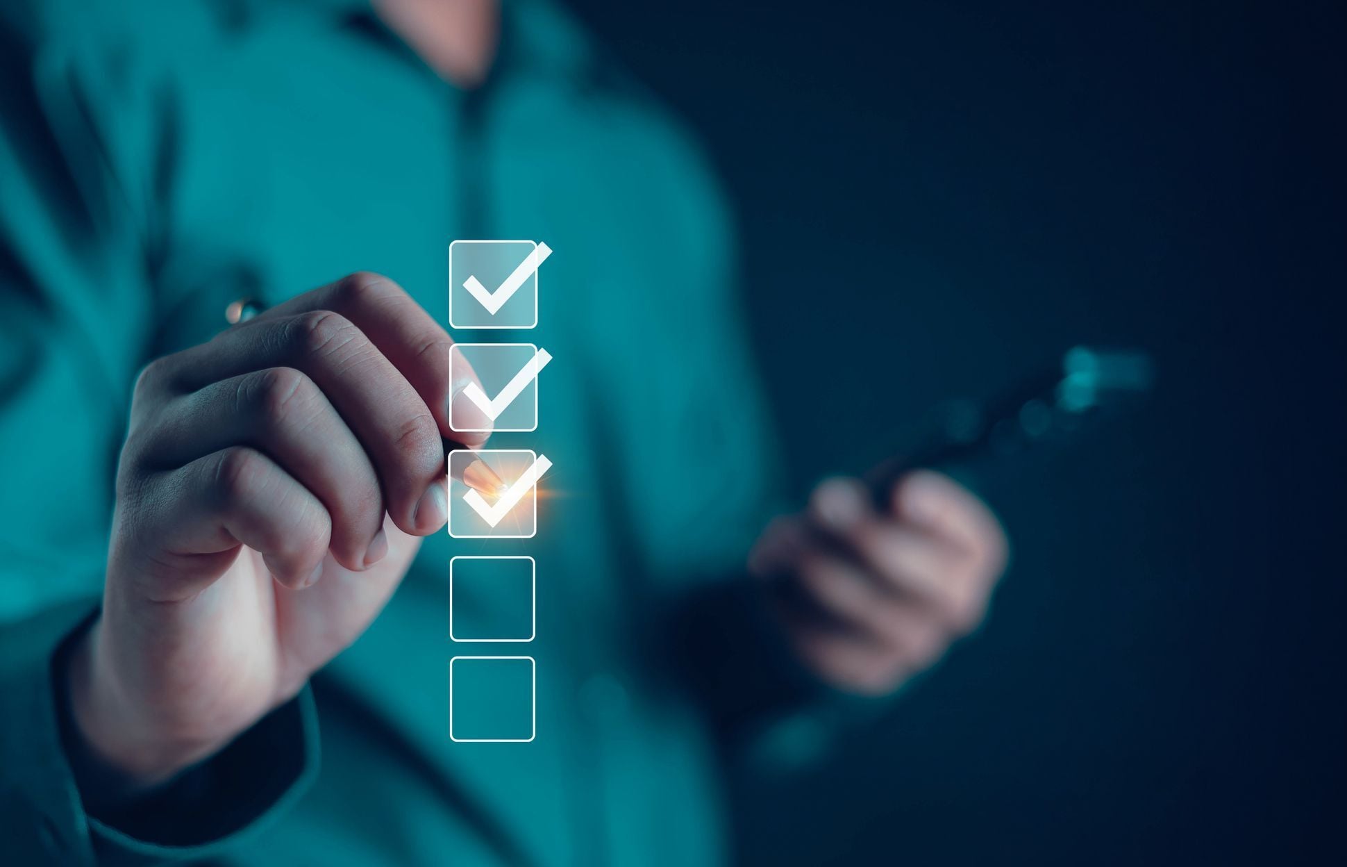 A close-up of a person checking off boxes on a digital interface while holding a smartphone, representing the comparison checklist users evaluate when choosing between financial modeling tools like Boldin vs ProjectionLab.