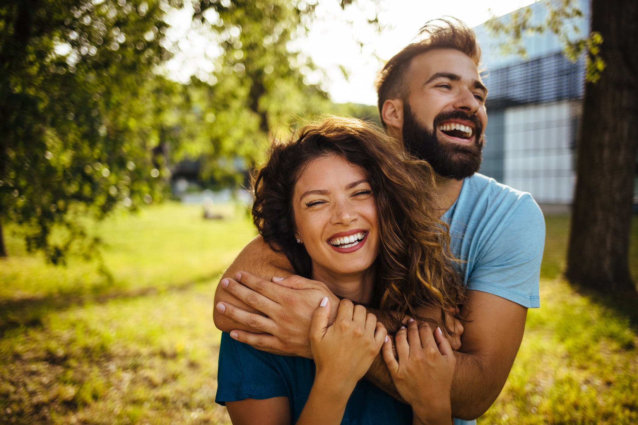 A happy couple laughing together, reflecting how the right spending shows that money can buy happiness.